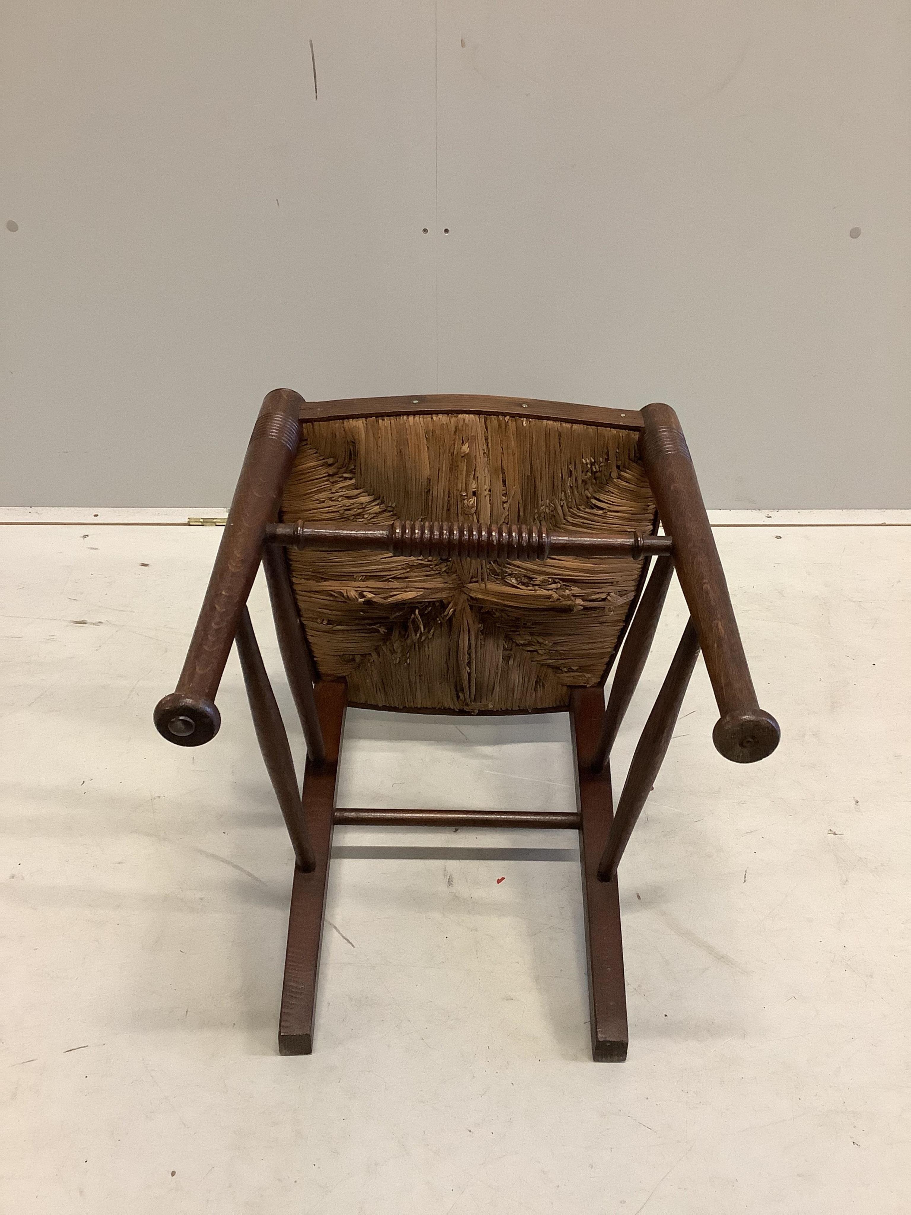 A Liberty & Co William Birch Arts and Crafts oak rush seat chair, width 40cm, depth 40cm, height 98cm. Condition - good.